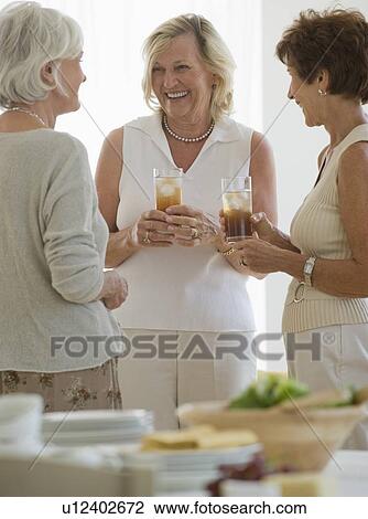 Senior women socializing at luncheon View Large Photo Image Stock Image - Senior women socializing at luncheon. Fotosearch