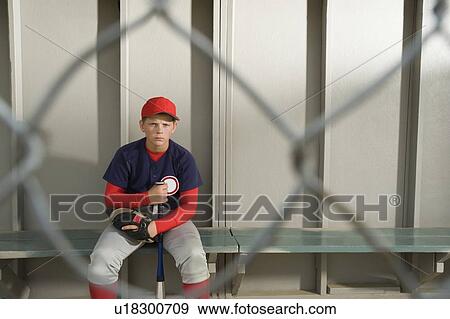 Serious baseball player sitting in dugout View Large Photo Image Stock Photo - Serious baseball player sitting in dugout. Fotosearch