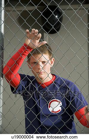 Serious baseball player standing in dugout View Large Photo Image Picture - Serious baseball player standing in dugout. Fotosearch