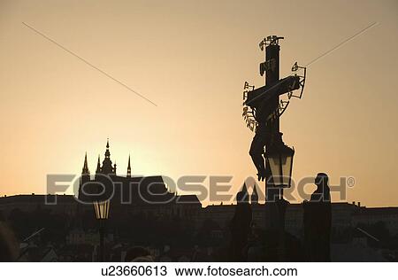 Stock Image - Silhouetted crucifix and cathedral. Fotosearch