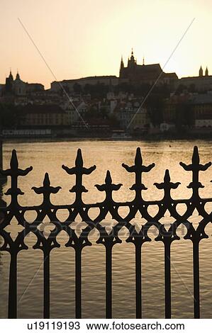 Stock Image - Silhouetted fence post and river. Fotosearch