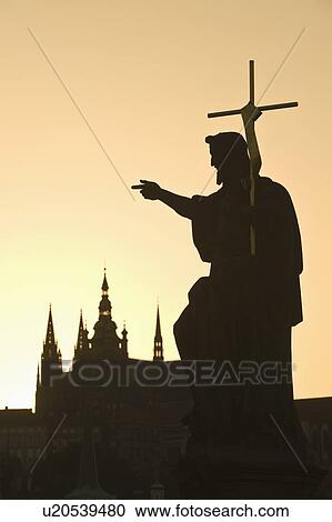 Stock Image - Silhouetted statue and cathedral. Fotosearch