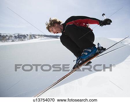Skier jumping off lip of half-pipe View Large Photo Image Stock Image - Skier jumping off lip of half-pipe. Fotosearch