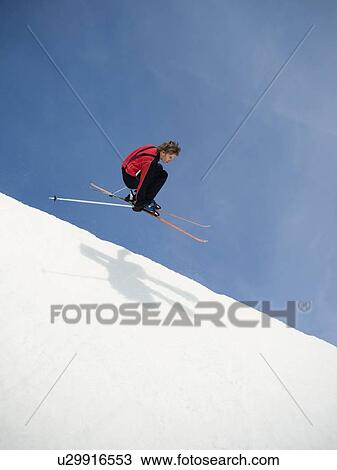 Stock Image - Skier jumping off lip of half-pipe. Fotosearch