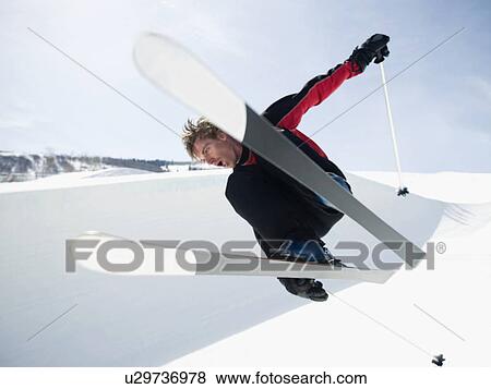 Stock Photo - Skier jumping off lip of half-pipe. Fotosearch
