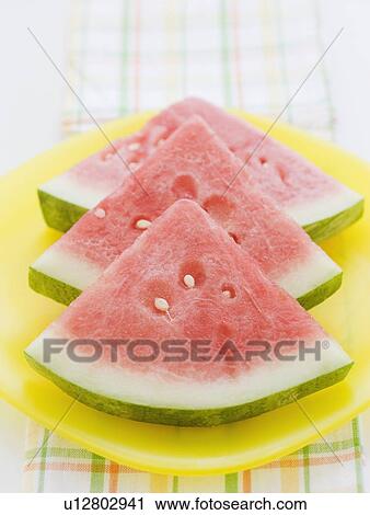 Sliced watermelon stacked in a row View Large Photo Image Stock Image - Sliced watermelon stacked in a row. Fotosearch