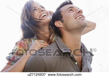 Smiling couple looking up View Large Photo Image Stock Photo - Smiling couple looking up. Fotosearch