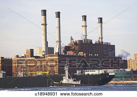 Stock Image - smokestacks and barge. Fotosearch