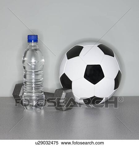 Soccer ball next to water bottle and dumbbell View Large Photo Image Stock Photography - Soccer ball next to water bottle and dumbbell. Fotosearch