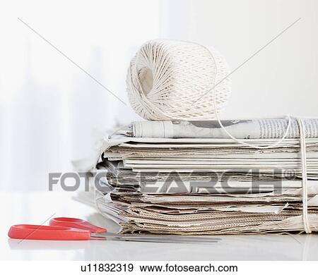 Stock Photo - String and scissors with newspaper bundle. Fotosearch