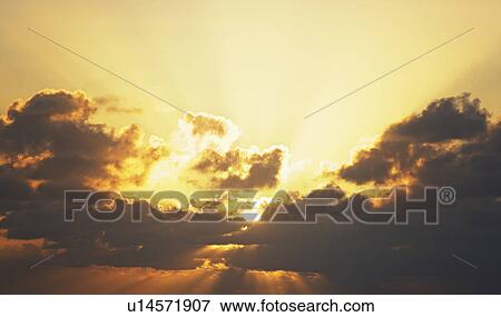 Sun shining through clouds View Large Photo Image Stock Photo - Sun shining through clouds. Fotosearch