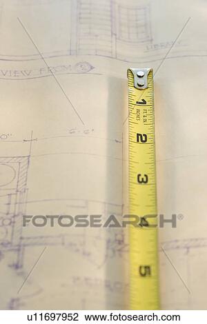 Stock Image - Tape measure on blueprint. Fotosearch