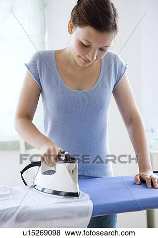 Teenage girl ironing clothes View Large Photo Image Stock Photo - Teenage girl ironing clothes. Fotosearch