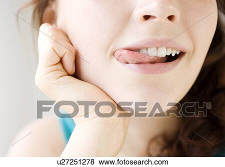 Teenage girl licking lips View Large Photo Image Stock Photo - Teenage girl licking lips. Fotosearch