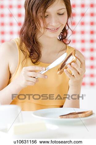 Stock Photograph - Teenage girl making toast. Fotosearch