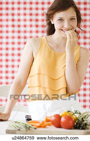 Teenage girl preparing fresh vegetables View Large Photo Image Stock Photo - Teenage girl preparing fresh vegetables. Fotosearch