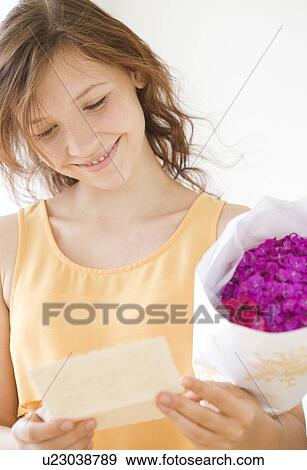 Teenage girl reading gift card View Large Photo Image Stock Photo - Teenage girl reading gift card. Fotosearch