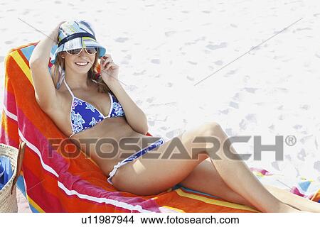 Picture - Teenage girl relaxing on beach. Fotosearch