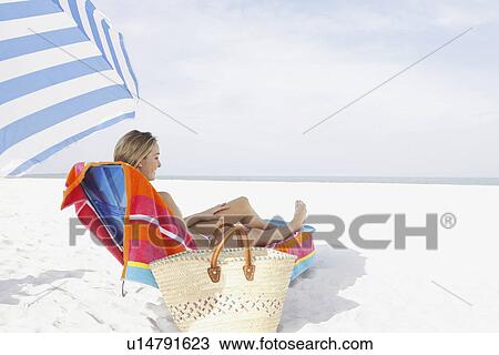 Teenage girl relaxing on beach View Large Photo Image Stock Image - Teenage girl relaxing on beach. Fotosearch