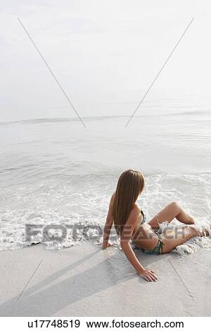 Teenage girl sitting in ocean View Large Photo Image Stock Photo - Teenage girl sitting in ocean. Fotosearch
