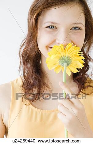 Teenage girl smelling flower View Large Photo Image Stock Image - Teenage girl smelling flower. Fotosearch