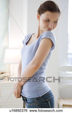 Teenage girl trying on new jeans View Large Photo Image Stock Photograph - Teenage girl trying on new jeans. Fotosearch