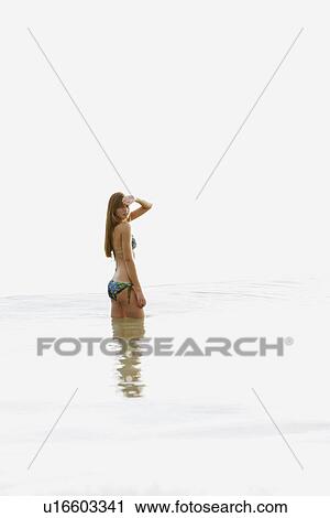 Teenage girl wading in ocean View Large Photo Image Stock Image - Teenage girl wading in ocean. Fotosearch