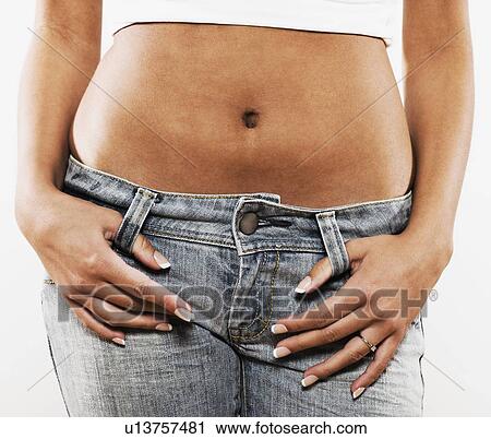 Teenage girl with bare midsection and thumbs in belt loops View Large Photo Image Stock Image - Teenage girl with bare midsection and thumbs in belt loops. Fotosearch