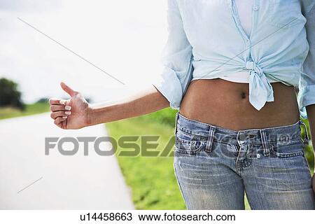 Teenage girl with bare midsection hitchhiking View Large Photo Image Stock Image - Teenage girl with bare midsection hitchhiking. Fotosearch
