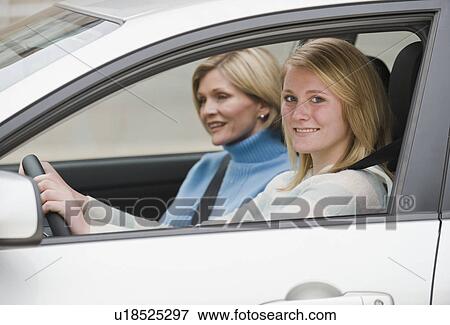 Teenaged girl driving with mother View Large Photo Image Stock Photo - Teenaged girl driving with mother. Fotosearch