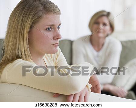 Teenaged girl looking away from mother View Large Photo Image Stock Photo - Teenaged girl looking away from mother. Fotosearch