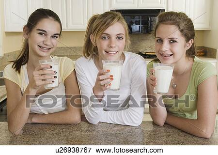 Teenaged girls drinking milk View Large Photo Image Stock Photo - Teenaged girls drinking milk. Fotosearch