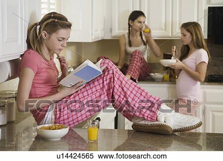 Teenaged girls eating breakfast View Large Photo Image Stock Photography - Teenaged girls eating breakfast. Fotosearch