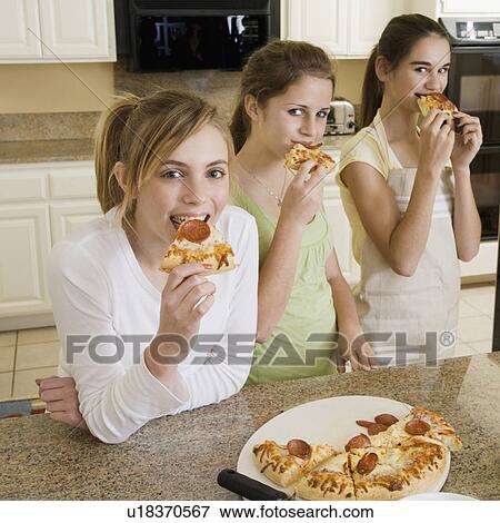 Teenaged girls eating pizza View Large Photo Image Stock Photo - Teenaged girls eating pizza. Fotosearch