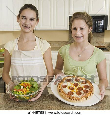 Teenaged girls holding salad and pizza View Large Photo Image Stock Image - Teenaged girls holding salad and pizza. Fotosearch
