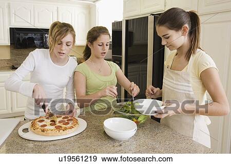 Stock Photo - Teenaged girls serving food. Fotosearch