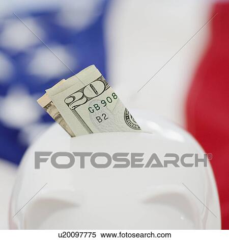 Stock Photography - Twenty dollar bill in piggy bank slot. Fotosearch