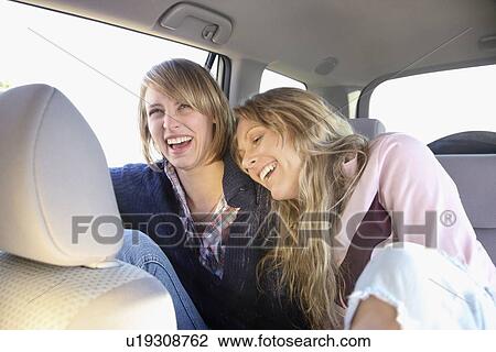 Two women in backseat of car View Large Photo Image Stock Image - Two women in backseat of car. Fotosearch
