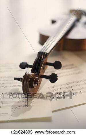 Violin laying on sheet music View Large Photo Image Stock Image - Violin laying on sheet music. Fotosearch