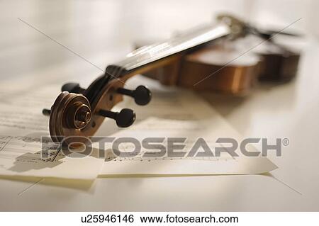 Violin laying on sheet music View Large Photo Image Stock Photograph - Violin laying on sheet music. Fotosearch