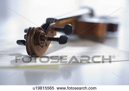 Stock Photography - Violin laying on sheet music. Fotosearch