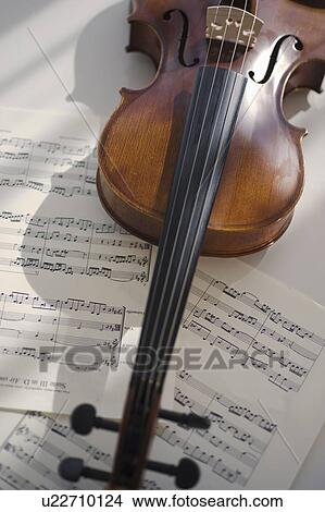Picture - Violin on sheet music. Fotosearch