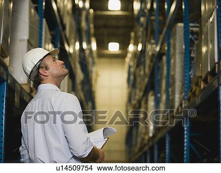 Picture - Warehouse worker checking inventory. Fotosearch