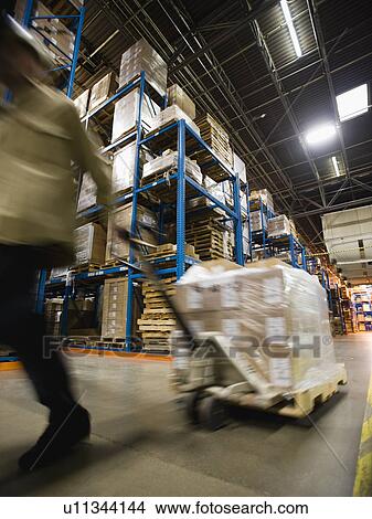Warehouse worker pulling palette View Large Photo Image Picture - Warehouse worker pulling palette. Fotosearch