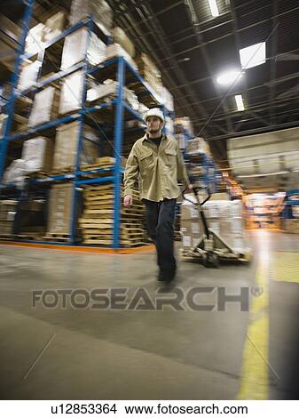 Warehouse worker pulling palette View Large Photo Image Picture - Warehouse worker pulling palette. Fotosearch