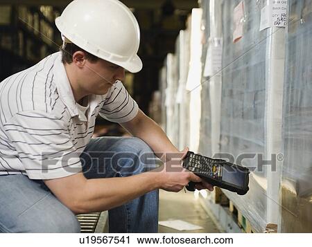 Stock Image - Warehouse worker scanning shipments. Fotosearch