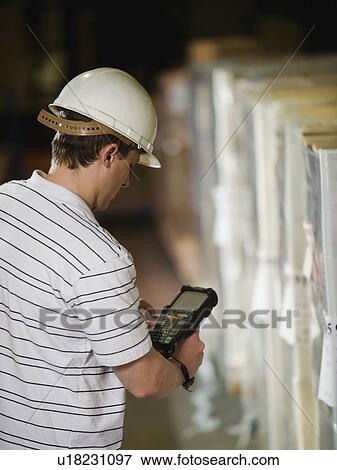 Warehouse worker scanning shipments View Large Photo Image Stock Photo - Warehouse worker scanning shipments. Fotosearch