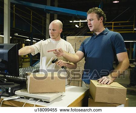 Stock Photography - Warehouse workers scanning packages. Fotosearch