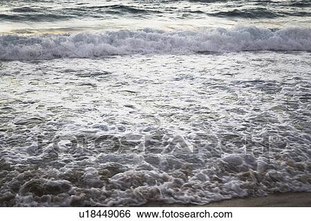 Stock Photograph - waves on the beach, erosion. Fotosearch