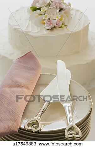 Stock Image - Wedding cake and stack of plates. Fotosearch